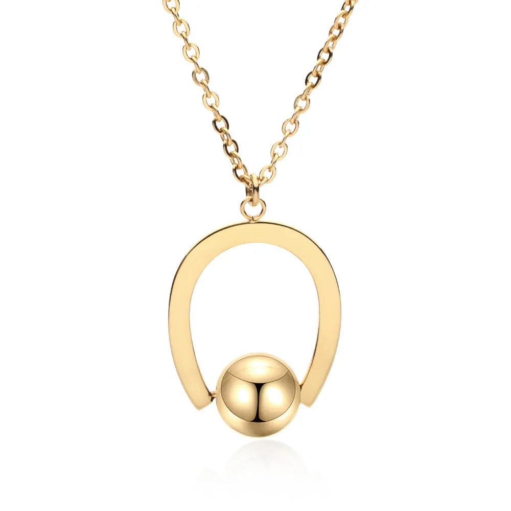 Gold tone stainless steel necklace with geometric pendant on a cross chain, shown adjusted to a medium length.