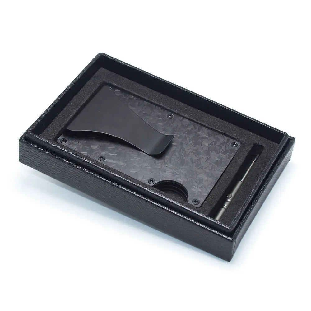 Slim black carbon fibre geometric wallet holding bank cards, showing 8mm thickness profile.