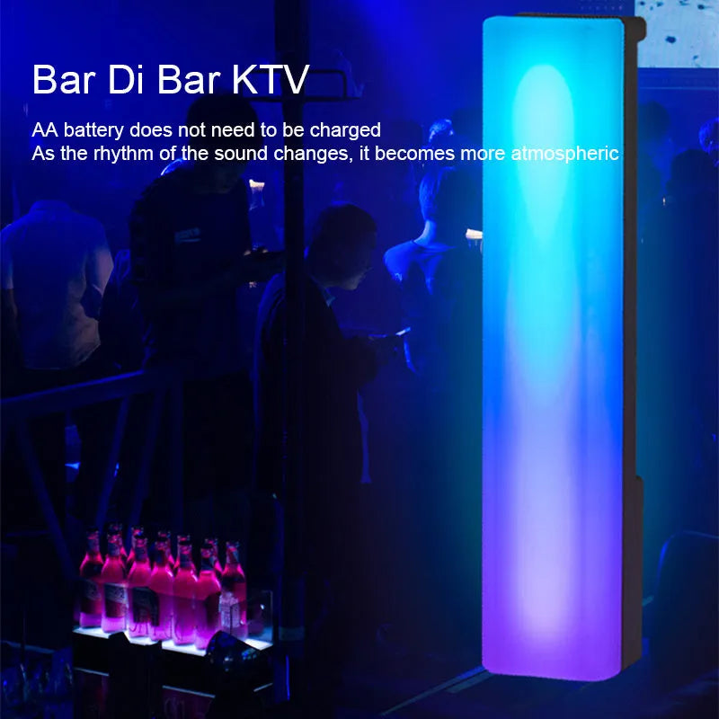 3D RGB music rhythm table lamp with voice control in black or white shell on a desk.