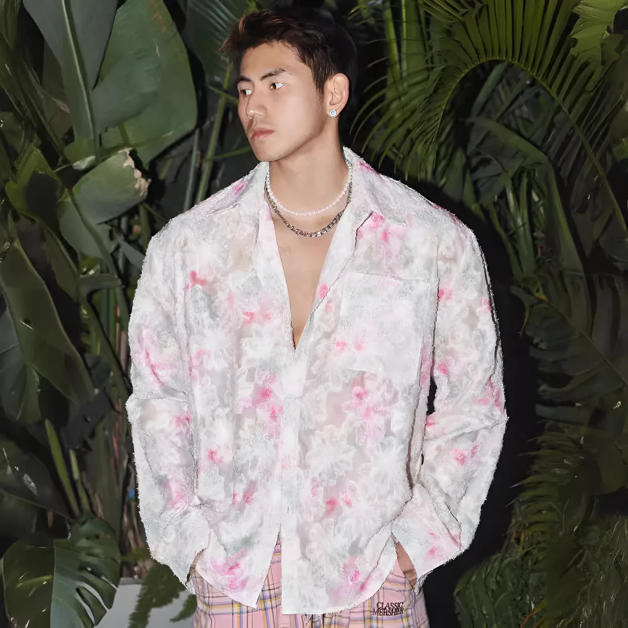 Women's pink embossed floral long sleeve loose-fit shirt on a hanger.