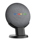 Black plastic stand holding Google Home Mini speaker on wooden desk
