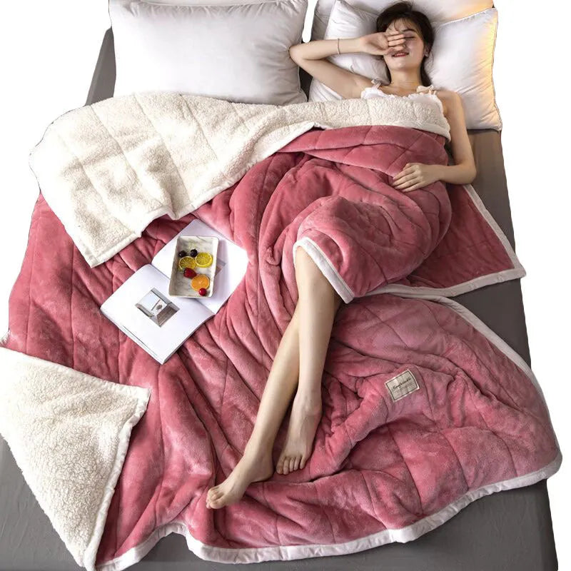 Thick coral fleece winter blanket in a solid colour, shown on a bed, dimensions 150cm by 200cm.