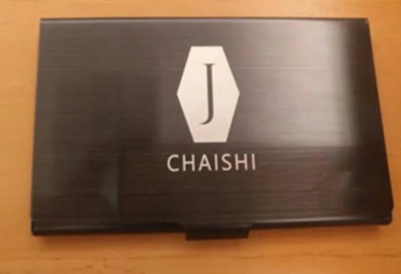 Metal titanium business card holder in black finish holding business cards