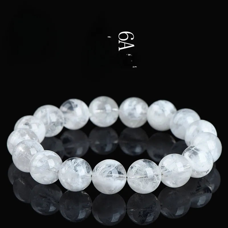Close-up of a clear crystal blizzard snowflake bead bracelet with Ruyi and Xiangyun design elements.