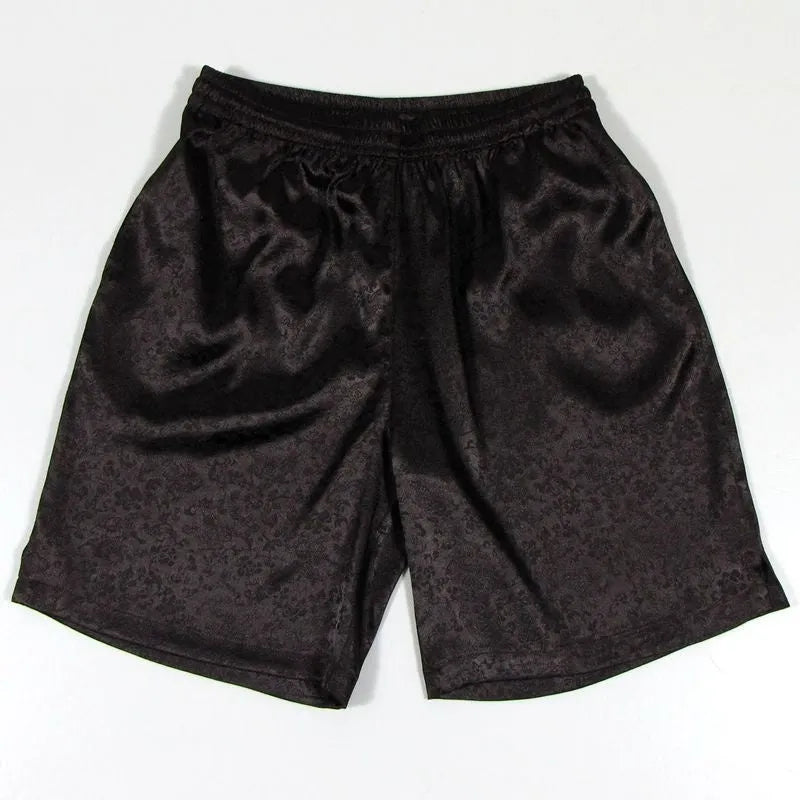 Man wearing traditional black Tang suit style Tai Chi shorts with an elastic drawstring waistband.