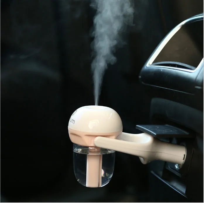 Compact blue portable car humidifier with essential oil diffuser on a car dashboard.