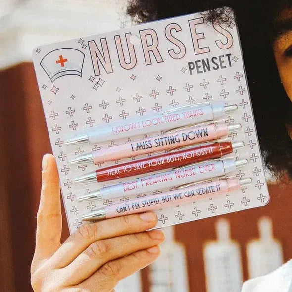 Five nurse-themed retractable ballpoint pens with humorous medical prints arranged together