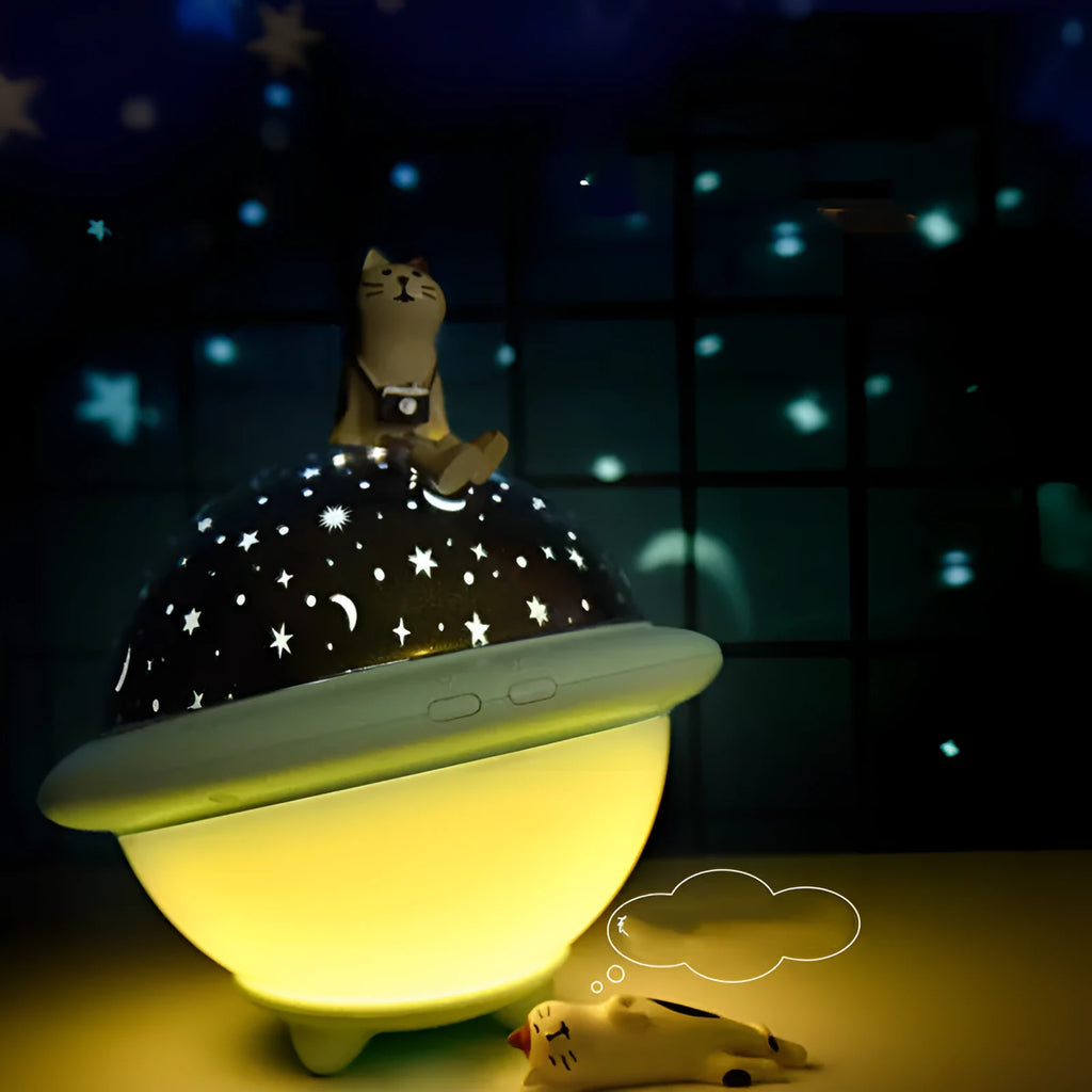 Pink UFO-shaped plastic LED night light projecting starry sky pattern on wall