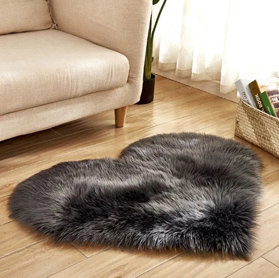 Heart-shaped plush carpet in multiple colours showing wool-like texture with 5-6 cm pile length