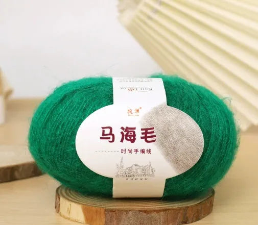 Ball of mohair yarn for DIY scarf knitting in one of 34 colours, including white, pink, blue, and green.