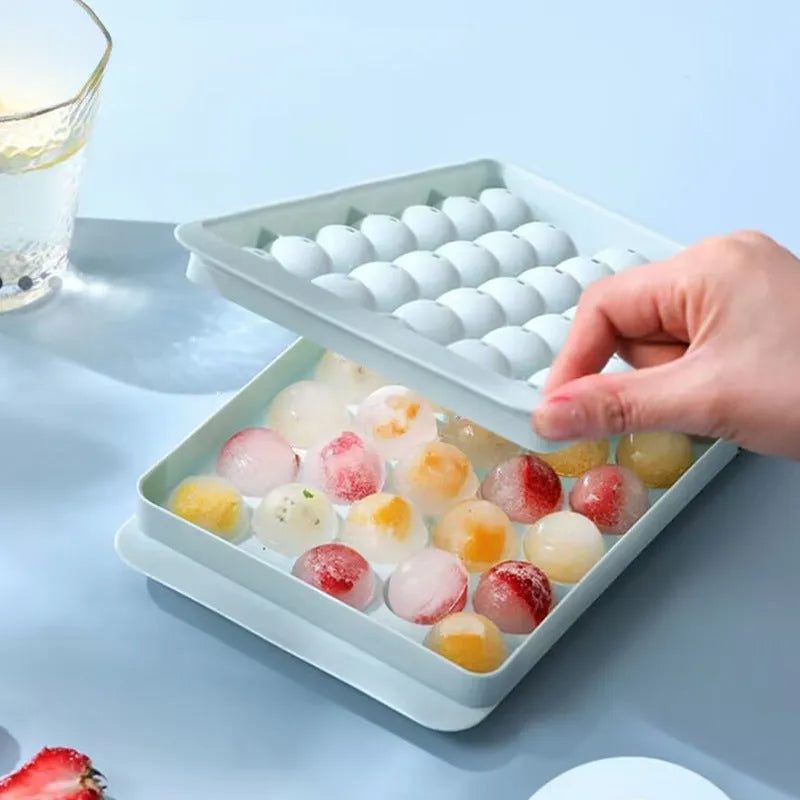 Blue silicone ice cube tray with lid showing 33 round cavities
