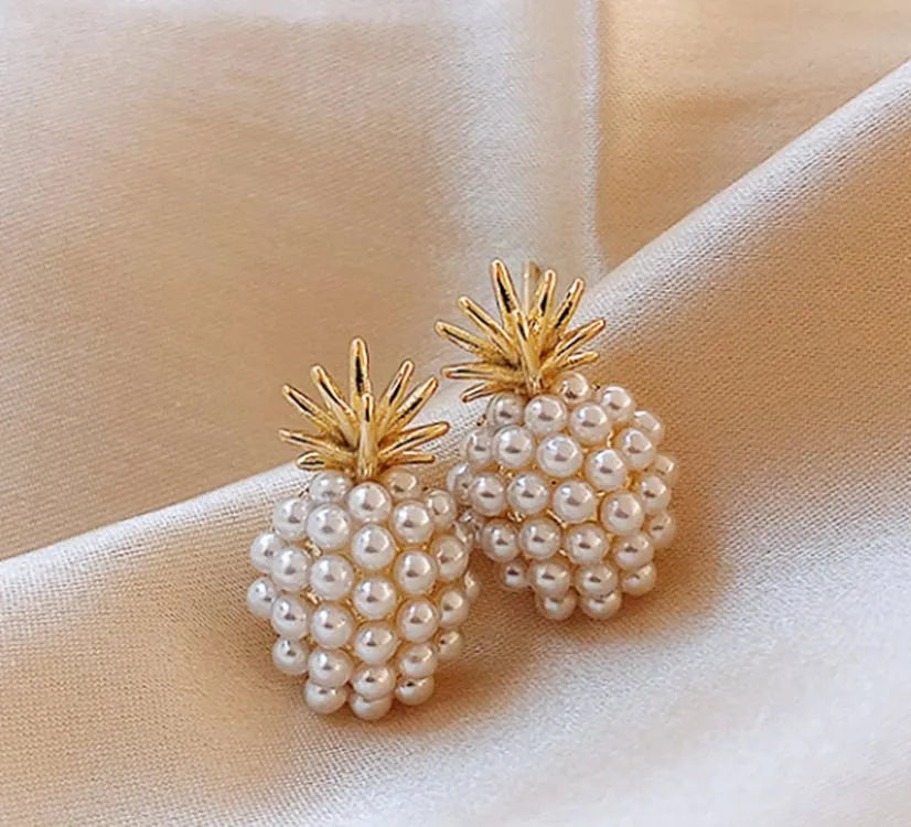 Gold pineapple and starfish pearl Korean style drop earrings with alloy electroplating and inlaid gems.