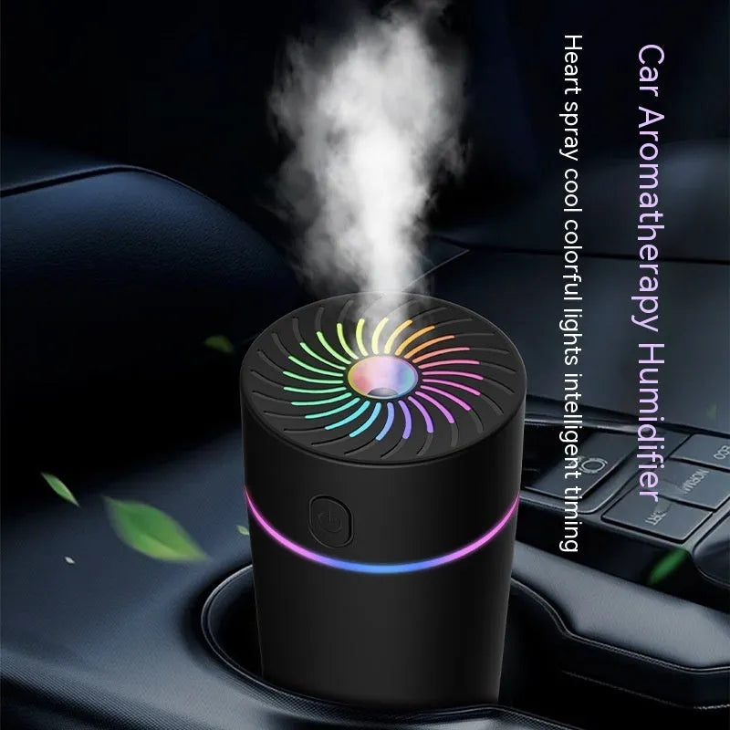 Small black and white car USB humidifier with aromatherapy function on a car dashboard.