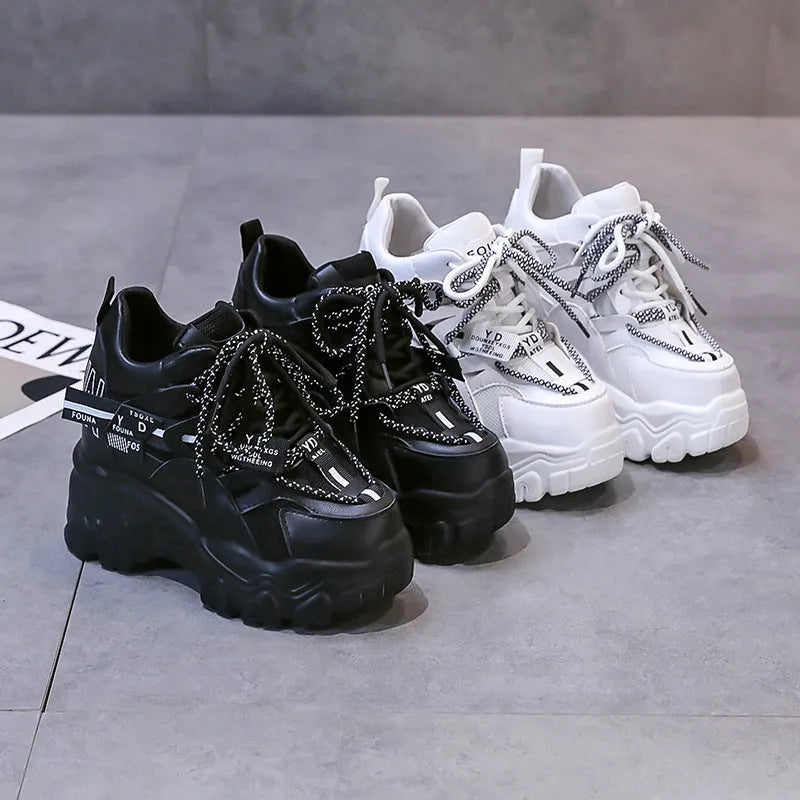 White women's low-top platform sports shoes with a cross-strap and breathable mesh upper on a rubber sole.
