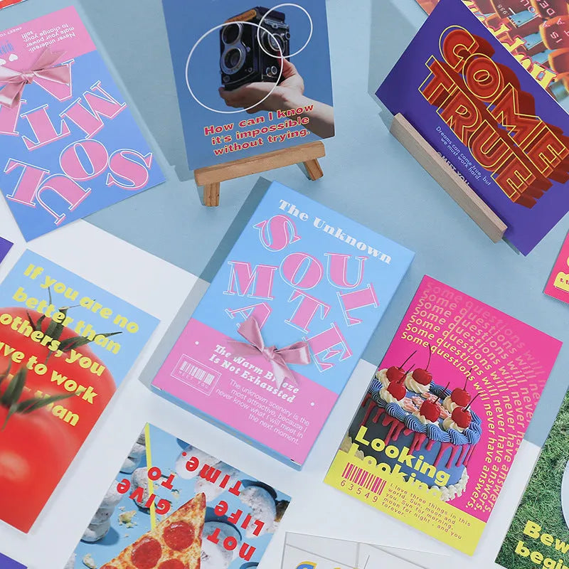 Box of fresh style creative postcards showing two different printed message designs.