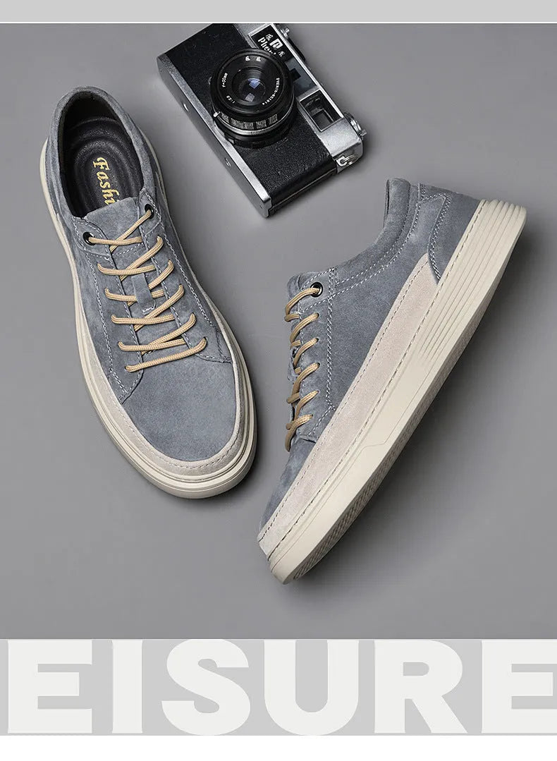 Men's grey casual leather skate shoes with low-top design and round toe on a rubber sole.