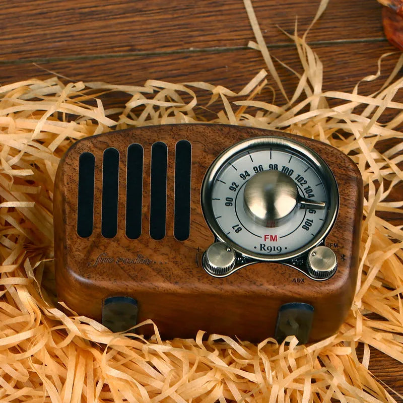 Retro wooden mini Bluetooth speaker in walnut finish showing front grille and side USB port