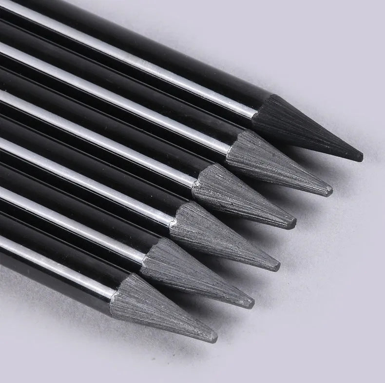 Set of six graphite and three carbonised art pencils in suction card packaging.