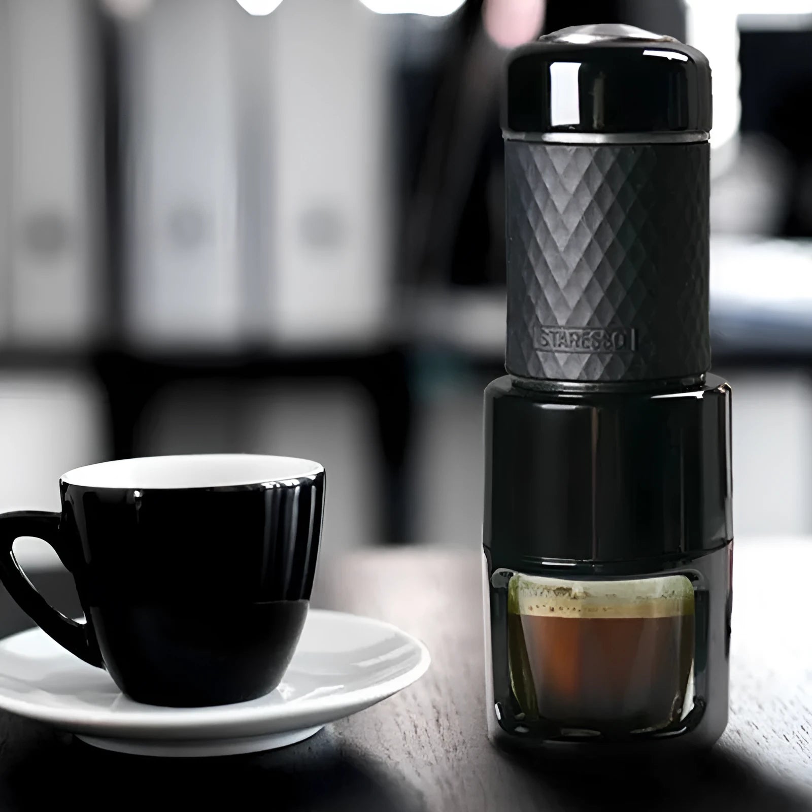 Portable manual espresso coffee machine in multiple colours showing compact design