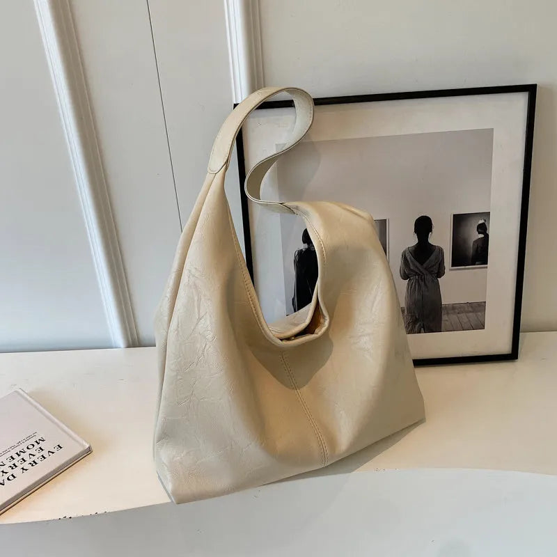 Soft PU leather large capacity shoulder bag in black with a sandwich pocket and contrasting stitching.