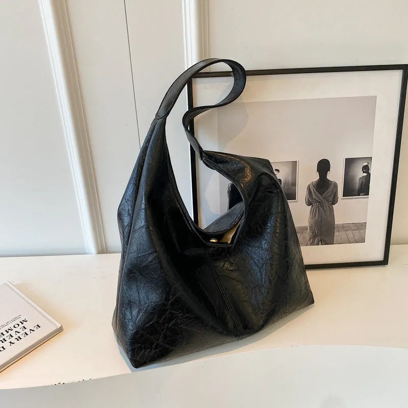 Soft PU leather large capacity shoulder bag in black with a sandwich pocket and contrasting stitching.