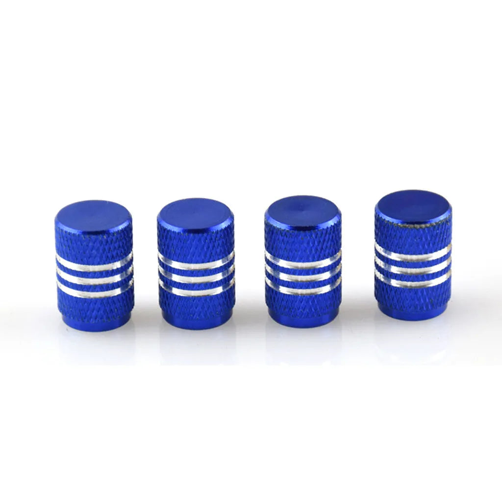 Assortment of aluminium alloy car tyre valve caps in ten different colours on a grey background.