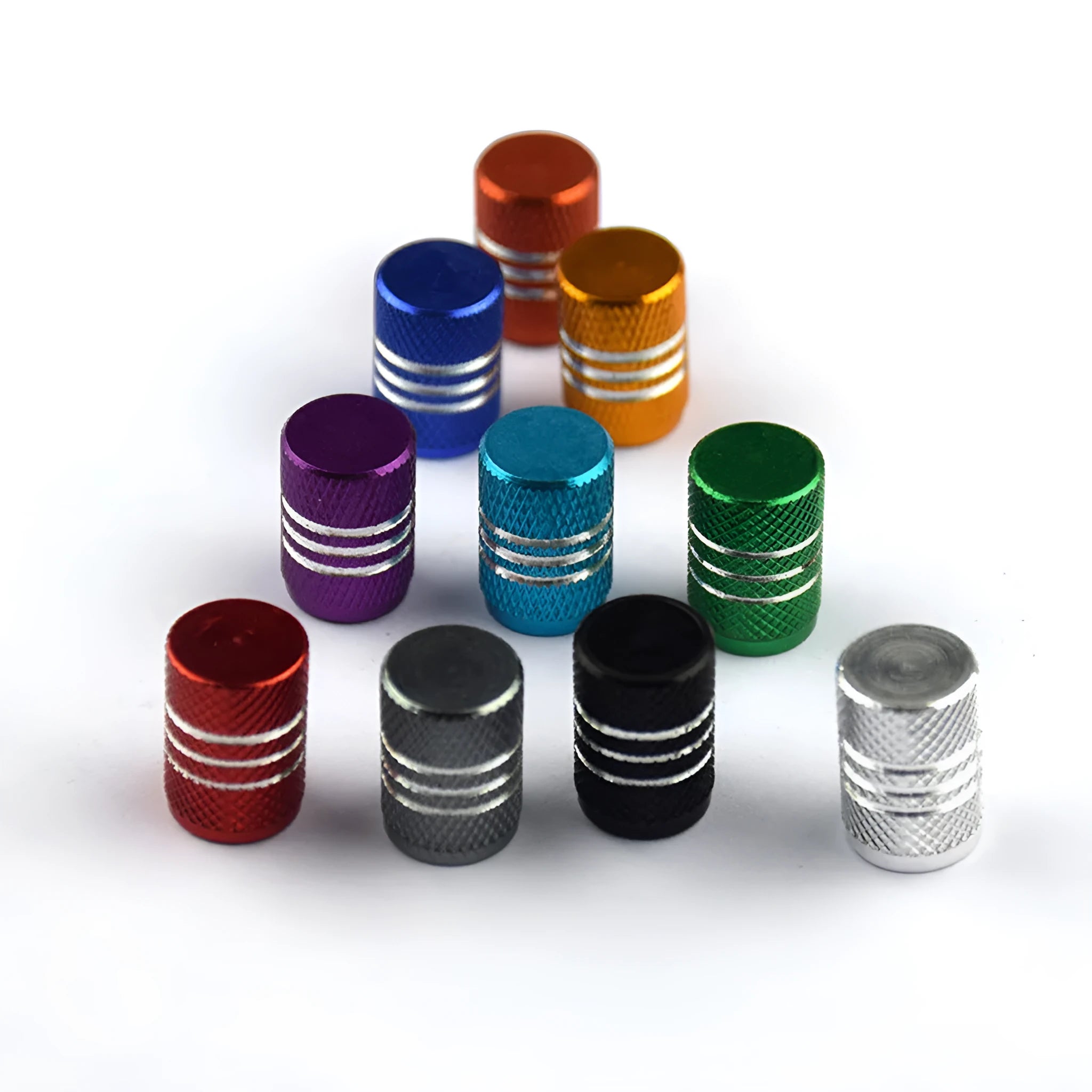 Assortment of aluminium alloy car tyre valve caps in ten different colours on a grey background.