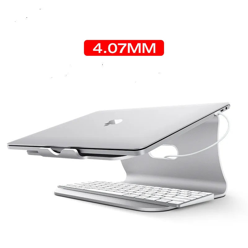Silver aluminium laptop cooling stand with rotary base on a wooden desk, elevating a laptop.