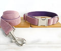 Pink purple nylon dog leash and collar set with reflective stripe on a black background, showing side view