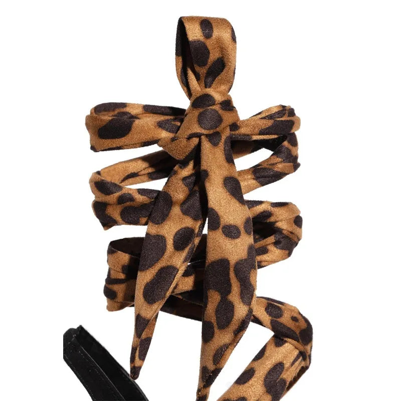 Light brown women's leopard print high heel sandals with cross-straps and a thin 8cm heel.