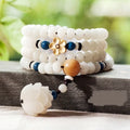 White jade bodhi seed bracelet with 6x8mm beads shown in multiple styles including cloisonne and lotus.