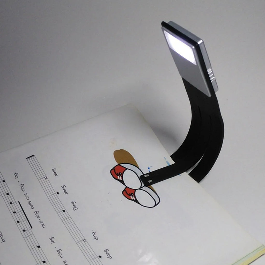 LEDGLE black USB rechargeable flexible clip LED book light with frosted panel and silicone arm on an e-reader