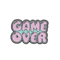 Solid alloy metal game console badge pin on a clear OPP packaging background.