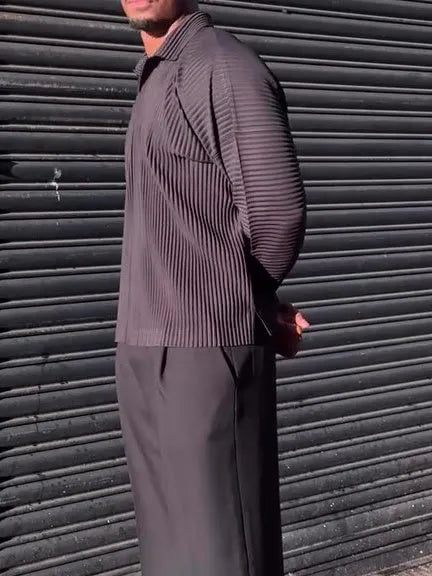 Man wearing a black pleated long-sleeved casual polyester top.