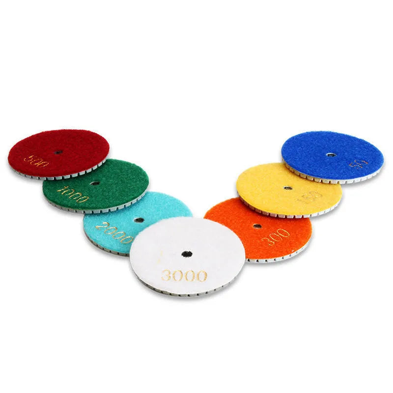 Set of 10 stone polishing pads with emery abrasive, showing 80mm diameter and central 10mm hole.