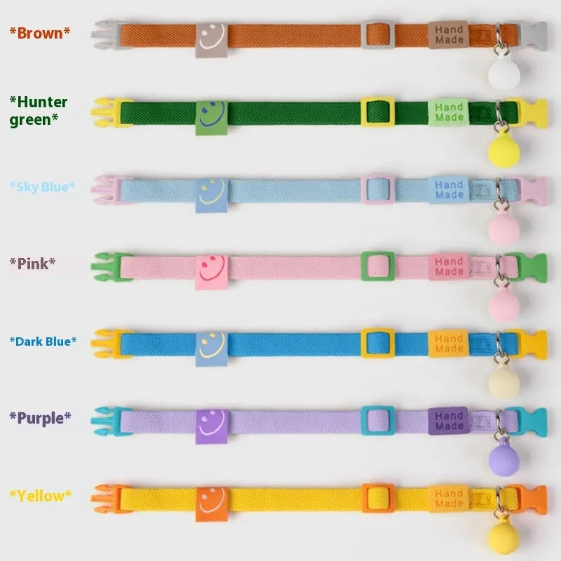 A stretchy yellow polyester dog collar for small breeds, shown adjusted to fit, with a metal D-ring.