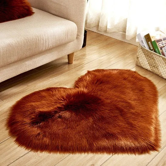 Heart-shaped plush carpet in multiple colours showing wool-like texture with 5-6 cm pile length