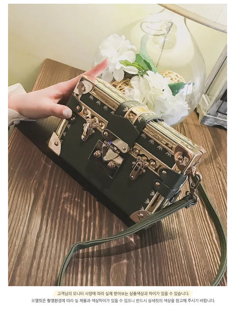 Women's black structured PU leather flap shoulder bag with cross-body strap and rivet details.