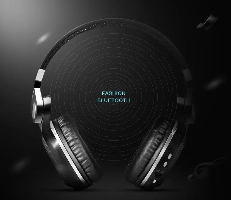 Black wireless Bluetooth headset with adjustable headband and over-ear cups on a grey background.