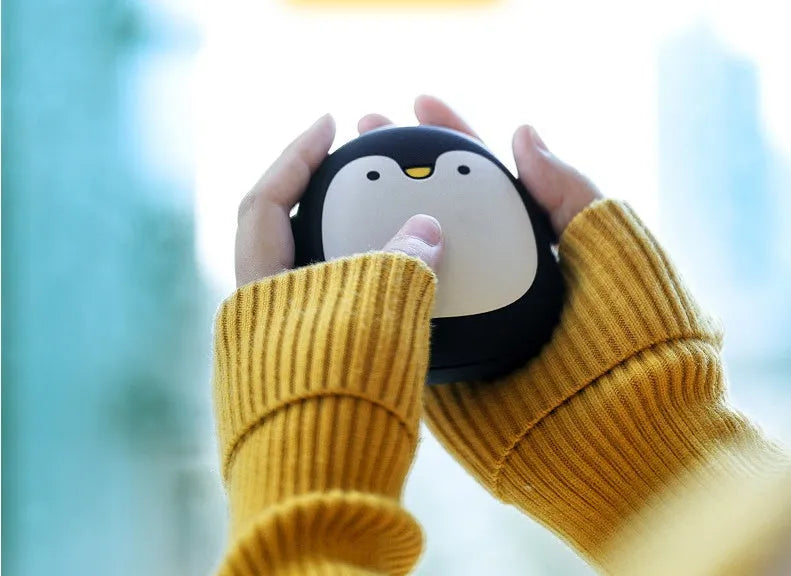 Cartoon penguin polar bear USB rechargeable hand warmer and power bank unit.