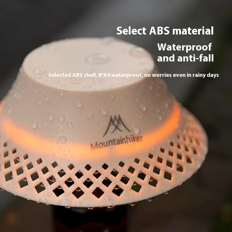 Beige wine bottle-shaped camping lantern with USB-C port and LED light on a wooden surface.
