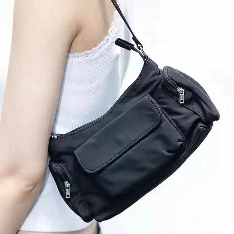 Black nylon lightweight shoulder bag with double pockets showing side line design detail