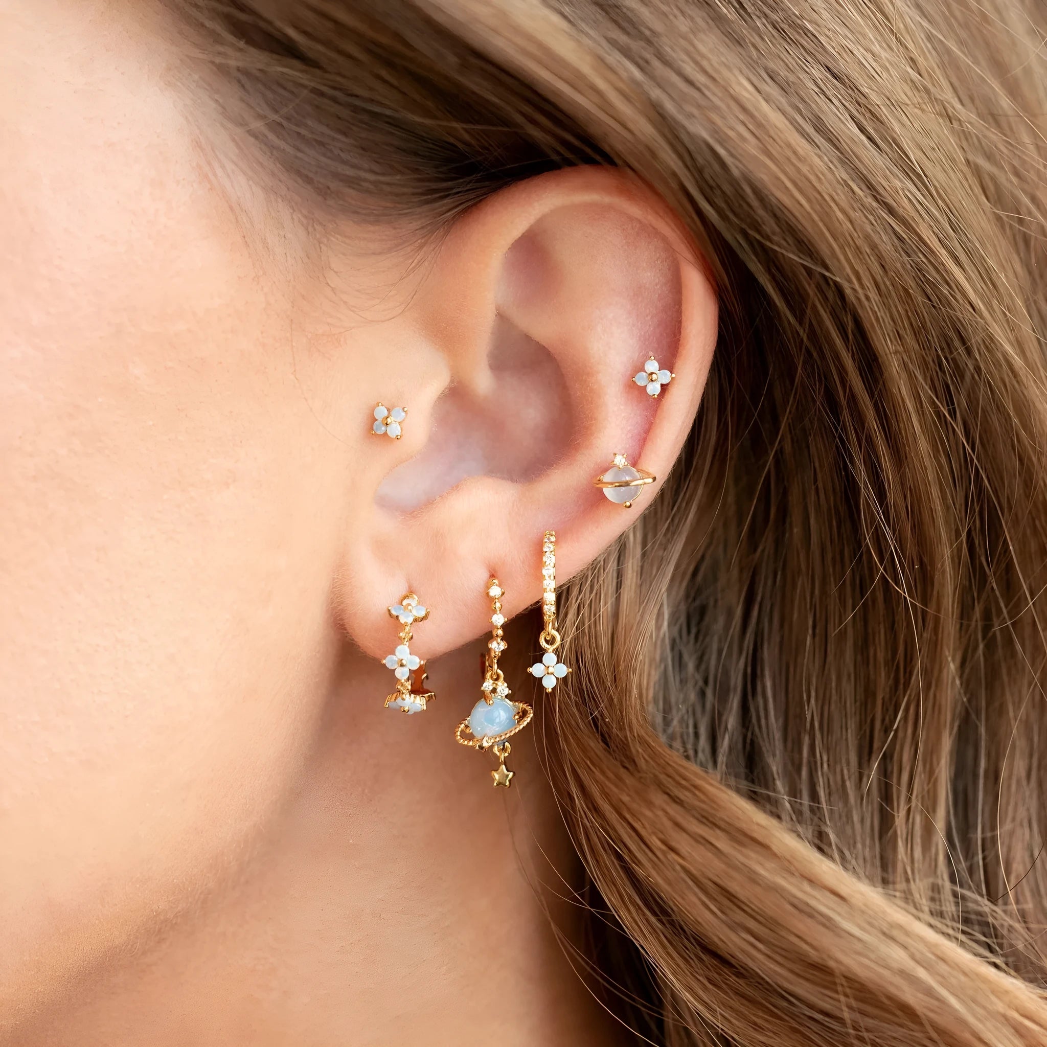Gold and silver floral ear studs with blue zircon flower nail detail in Japanese Korean style