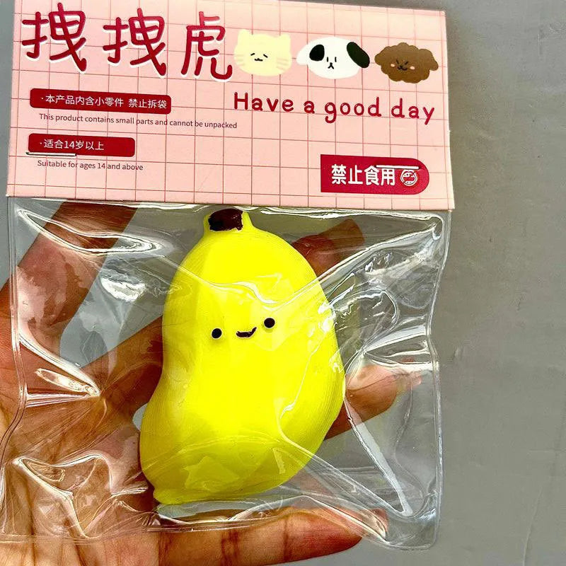 Chubby banana squeezing toy in yellow TPR shape with soft texture on plain background