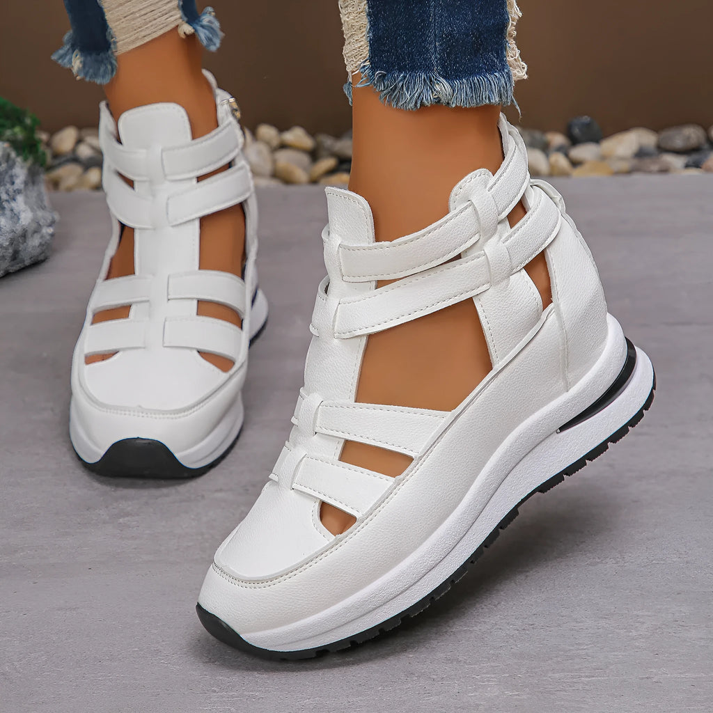 Women's black platform sandal with closed toe, hollow-out design, and Velcro ankle strap.