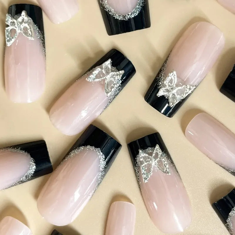 Black French style artificial nails with glitter butterfly design in medium length