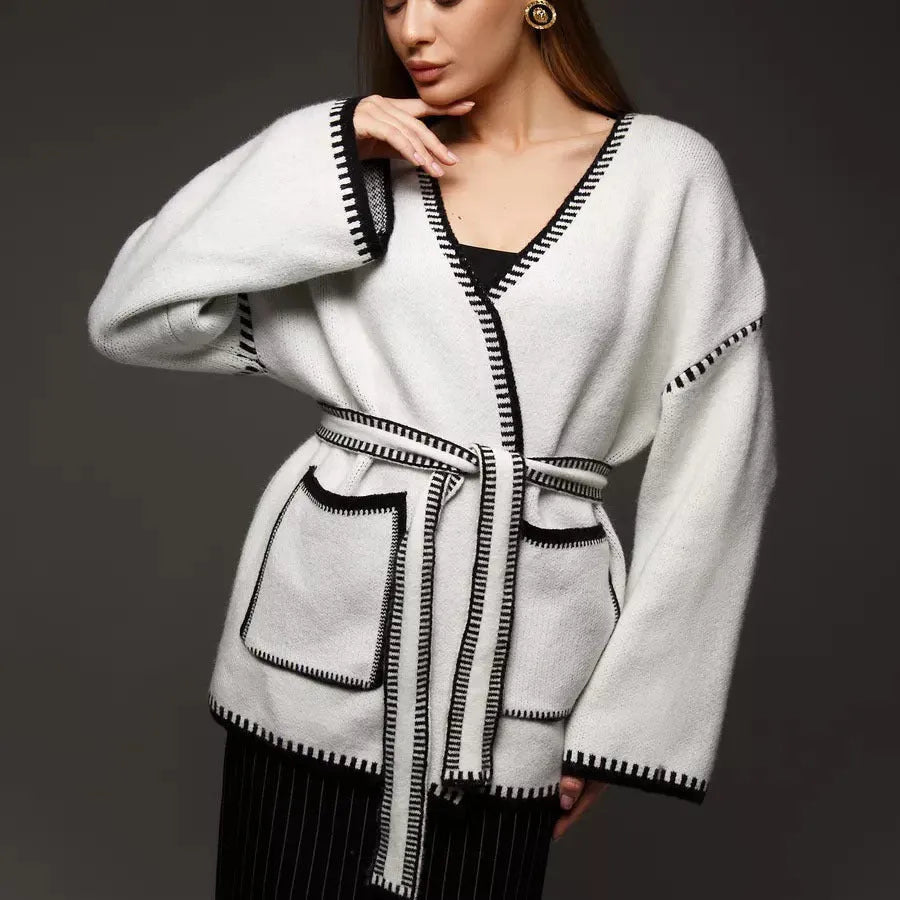 Lace-up front knitted cardigan in black, camel, or white, showing loose fit and thick fabric.