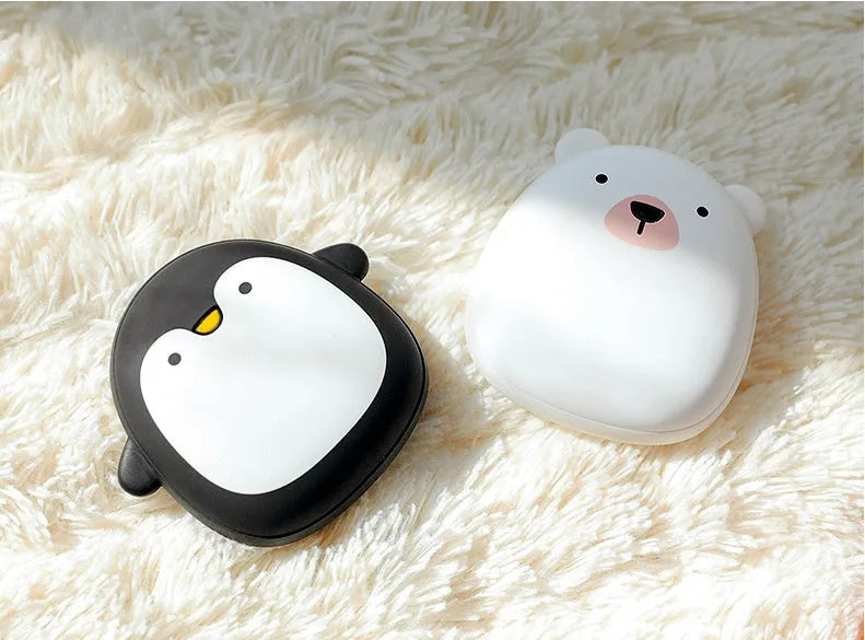 Cartoon penguin polar bear USB rechargeable hand warmer and power bank unit.
