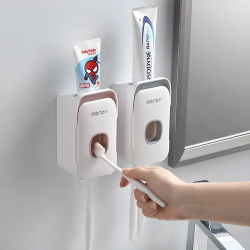 Blue automatic toothpaste dispenser made of ABS plastic mounted on a bathroom wall.