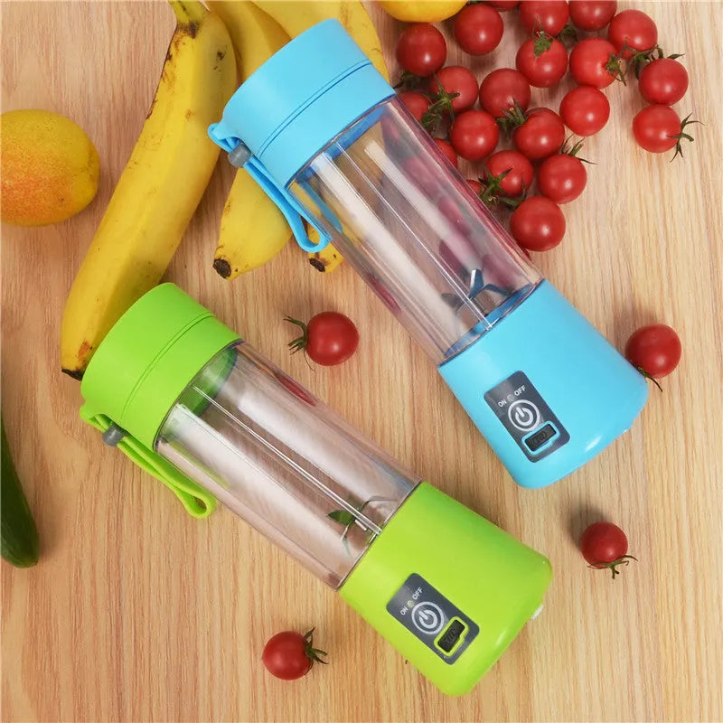 Mini USB-powered centrifugal fruit juicer in pink, with a 400ml plastic cup and stainless steel blade.
